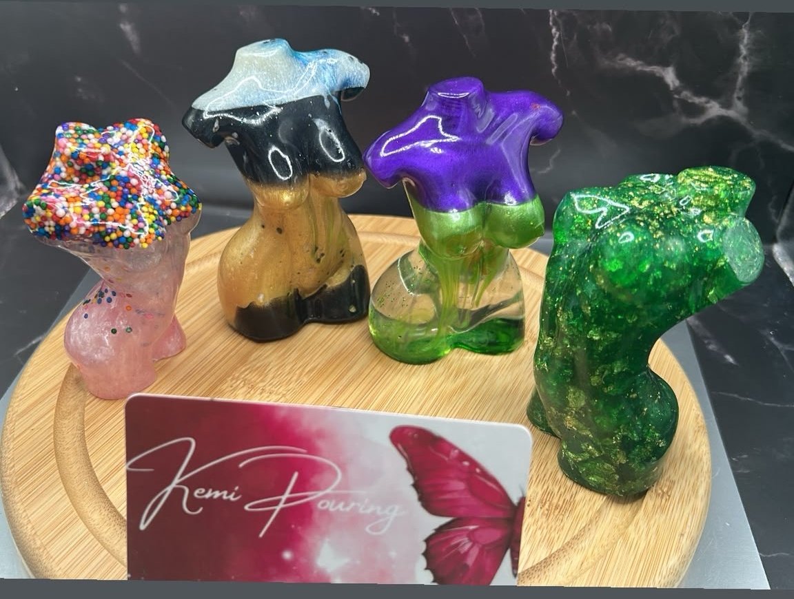 Four colorful handmade resin body sculptures