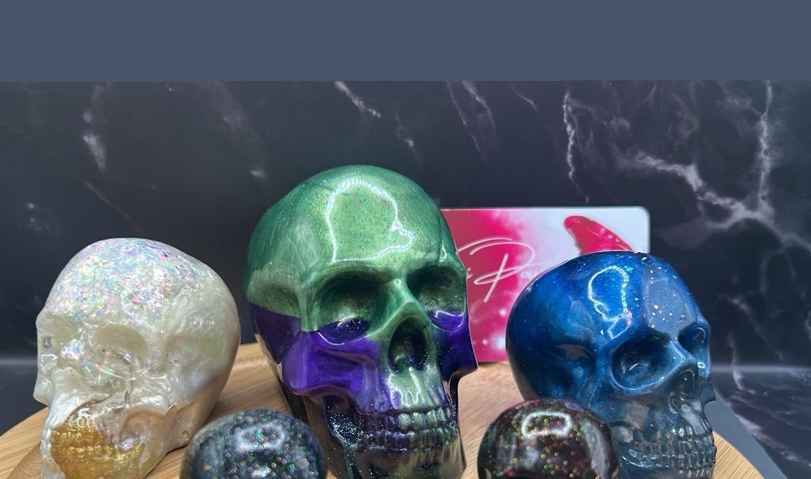 Handmade resin skeleton heads available in small, medium, and large sizes
